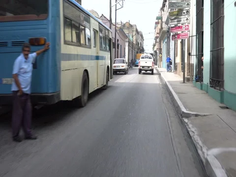 Fast movement behind white car on the narrow street in cuban city Stock Footage 71533689