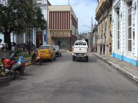 Fast movement behind white modern car on the narrow street in cuban city Stock Footage 71534428
