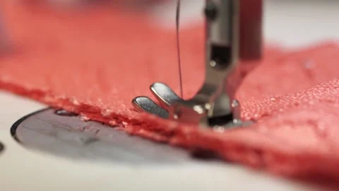 Fast movement of the sewing machine needle on the blue fabric. The needle of the Stock Footage 192434903