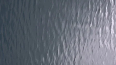 Fast moving above of the smooth surface of beautiful sea, in the background high Stock Footage 83721992