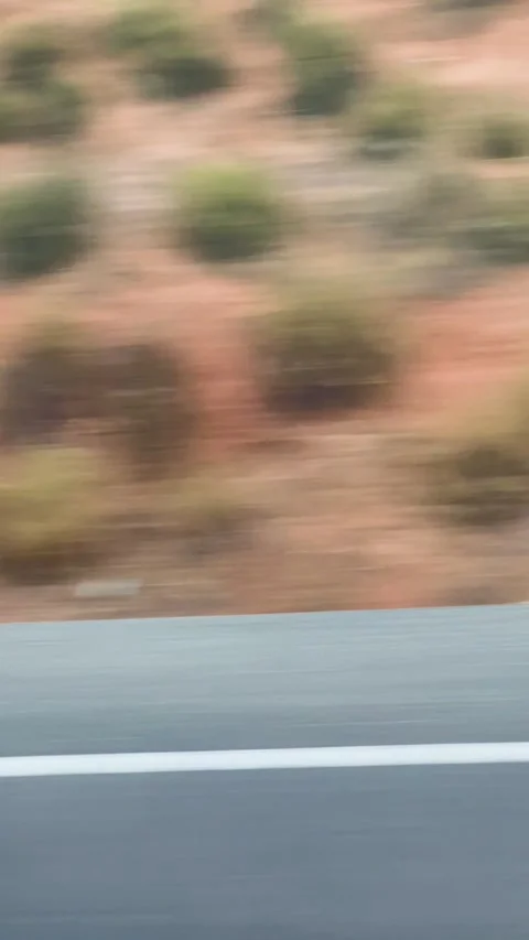 Fast moving car point of view looking out the window at the blurred asphalt Stock Footage 343353493