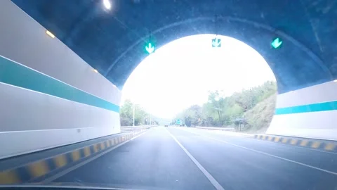 A fast moving car through an underground tunnel to the main road Stock Footage 152828198