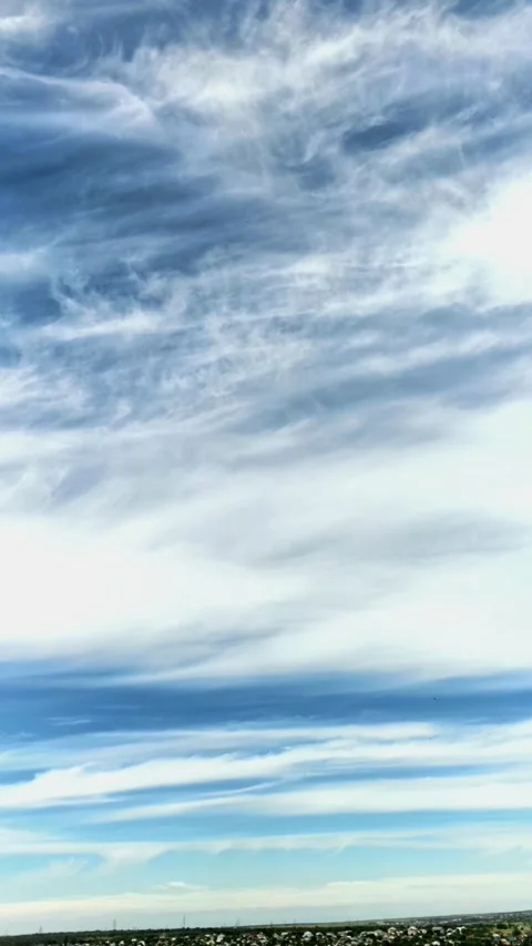 Fast moving cirrus clouds cross a blue sky in time lapse, atmospheric motion, Stock Footage 339761814