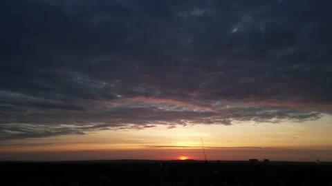 Fast moving clouds changing colour during sunrise Vidéo 237718687