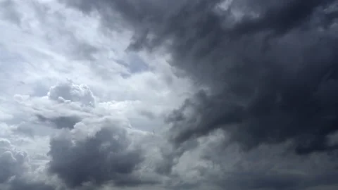 Fast-moving clouds converge in the sky Stock Footage 339784059