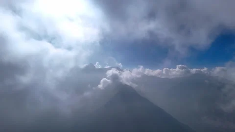 Fast-moving clouds dance over majestic mountain peaks in stunning aerials. Stock Footage 316359838