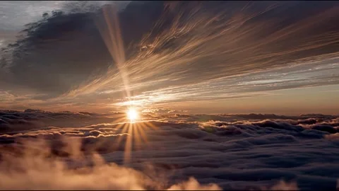 Fast-moving clouds drift across the vibrant sky as the sun sets Video stock 314826138