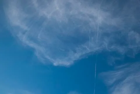 Fast moving clouds during a sunny day in the blue sky with the transition to  Stock-Fotos
