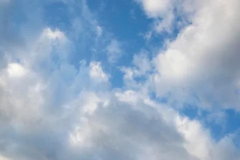 Fast moving clouds during a sunny day in the blue sky with the transition to  写真素材