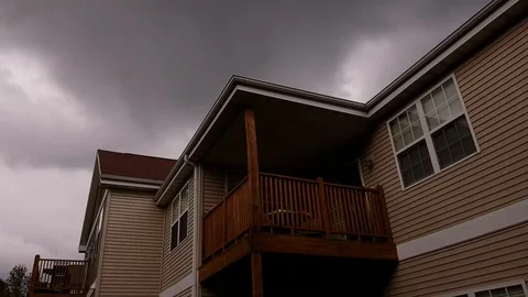 Fast moving clouds in grey sky over rooftop 4k Stock Footage 97092286