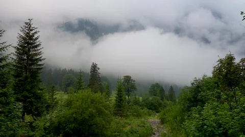 Fast moving clouds in mountains alps Video stock 96990233