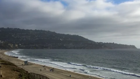 Fast moving clouds over beach 스톡 동영상 274868664