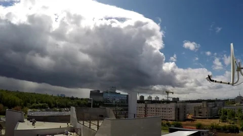 Fast moving clouds over the city. Satellite dish on the background of sky Stock Footage 52963386