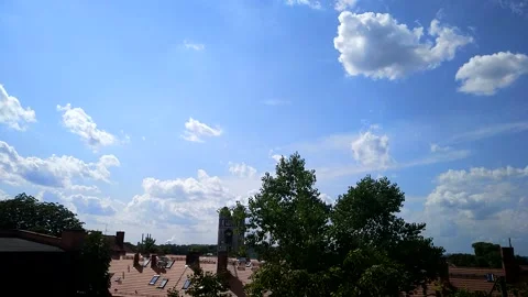 Fast moving clouds over cityscape timelapse Stock Footage 168523147