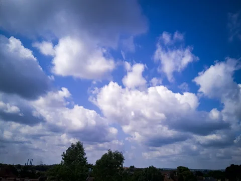 Fast moving clouds over a cityscape Stock Footage 168526636
