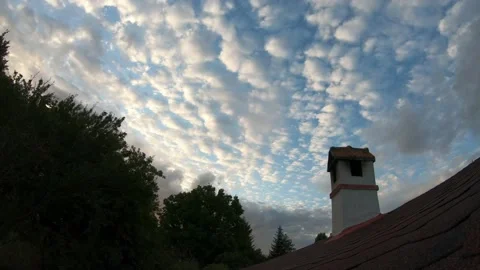 Fast moving clouds over a house chimney and roof, timelapse Stock Footage 199064792
