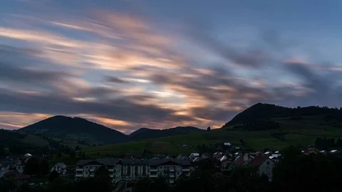 Fast moving clouds over rural countryside in evening. Day to night time lapse 스톡 동영상 80377023