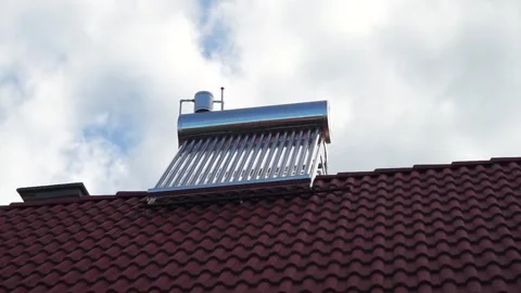 Fast moving clouds over a solar water heater boiler Stock Footage 312131008