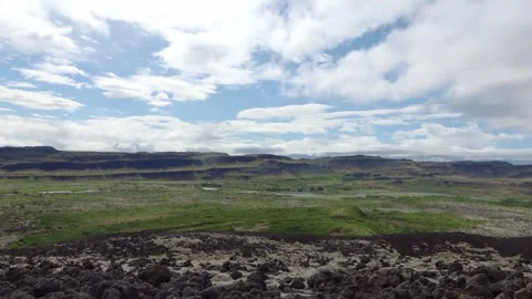 Fast moving clouds passing over a vast Icelandic volcanic field and green mossy Stock Footage 346326368