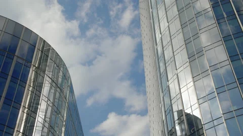 Fast moving clouds reflected on office buildings glass Stock Footage 187661538