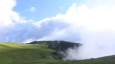 Fast moving clouds rising from the valley, on the high mountain grassland Stock Footage 64891898