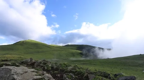 Fast moving clouds rising from the valley, on the high mountain grassland Stock Footage 64901421