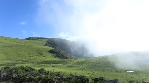 Fast moving clouds rising from the valley, on the high mountain grassland Stock Footage 64911688