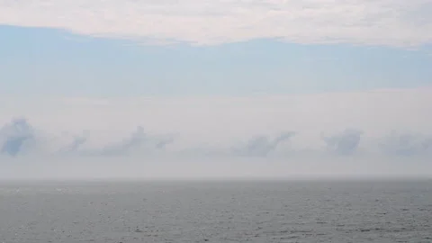 Fast moving of clouds on sky and fog over water surface of sea Stock Footage 296121613