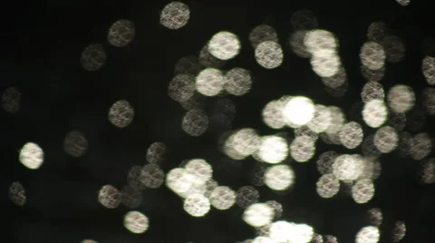 Fast moving crowded shining sparkles on dark water background. Vídeo Stock 47221450