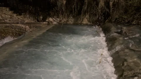 Fast-moving current of a pristine river flowing over rocks and through Stock Footage 339651572