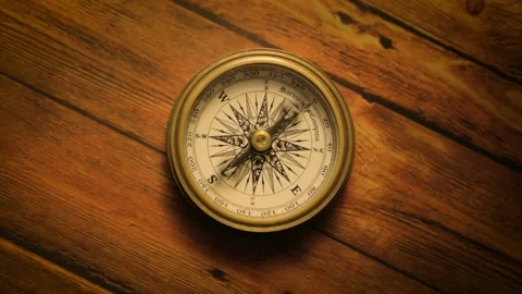 Fast moving dial of Compass on wooden base historic medieval looking object Stock Footage 156644545