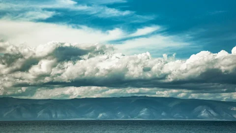 Fast moving dramatic clouds over the lake Baikal Cloudscape timelapse Video stock 108040684