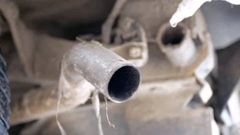 Fast moving exhaust tailpipe on old petrol engine car Stock Footage 122688384