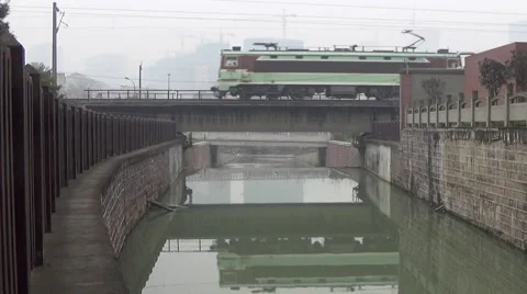 Fast moving freight train going through a bridge above a river Stock Footage 45905968