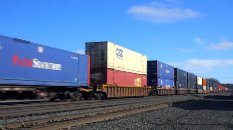 A fast moving freight train passes with many containers. Stock Footage