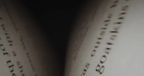 Fast moving macro shot viewed text inside book. Book sheets close-up with text Stock Footage 230692306