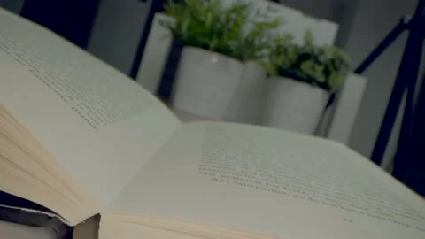Fast moving macro view past inside of book as it slowly closes filmed in 4k. Clo Stock Footage 135123604