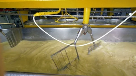 Fast moving milk stirrers in close view. Stock Footage