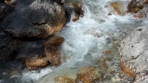 Fast moving mountain stream in sunlight Stock Footage 96062055