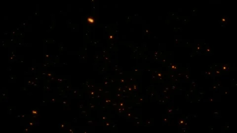 Fast moving orange particles streaking through dark space with cinematic speed Vídeo Stock 334568204