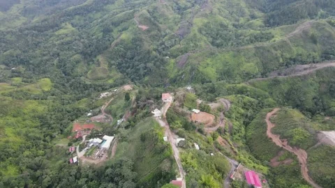 A Fast moving rotating bird's eye view shot of houses trees and mountains Stock Footage 165176016