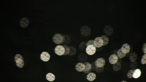 Fast moving segmental shining sparkles on dark water background. Видео 47221458