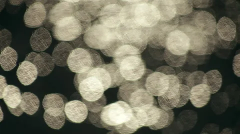 Fast moving shining sparkles on dark wavy water background. Видео 47012117