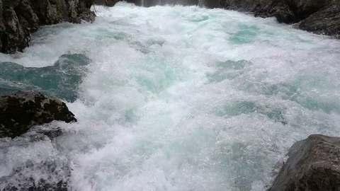 A fast-moving stream of the mountain river Stock Footage 72424861