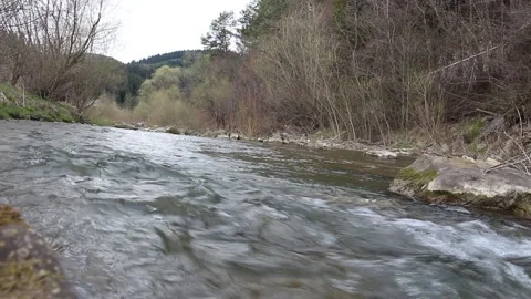 A fast-moving stream of the river in the mountains Stock Footage 153422297