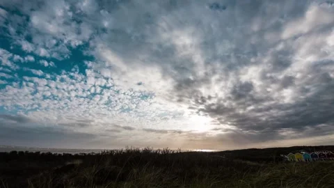 Fast moving summer sky clouds over golden crop field polarized Stock Footage 244154751