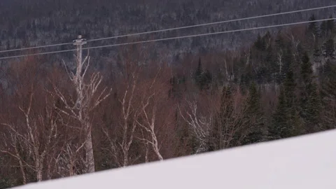 Fast moving tight shot of ski lifts moving through frame in new england Stock Footage 147363697