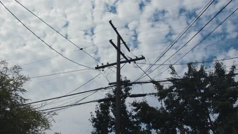 Fast Moving Timelapse of Clouds behind a Residential Power Line and Phone Line Stock Footage 137925967