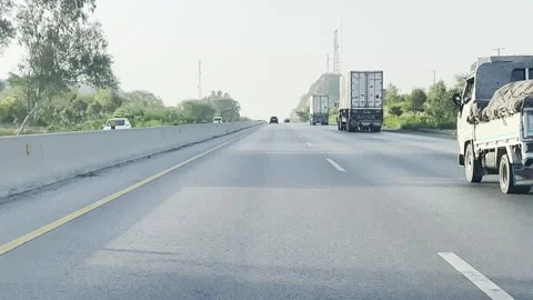 Fast moving traffic on motor way M2 in Islamabad, Pakistan on May 20, 2025. Stock Footage 310261017