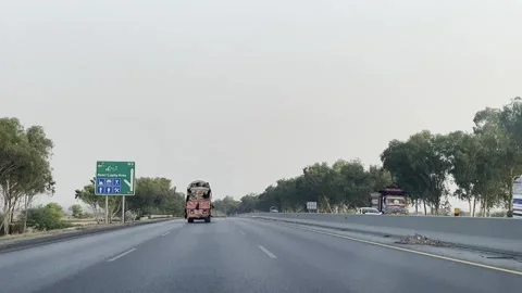 Fast moving traffic on motor way M2 in Islamabad, Pakistan on May 20, 2025. Stock Footage 310282950